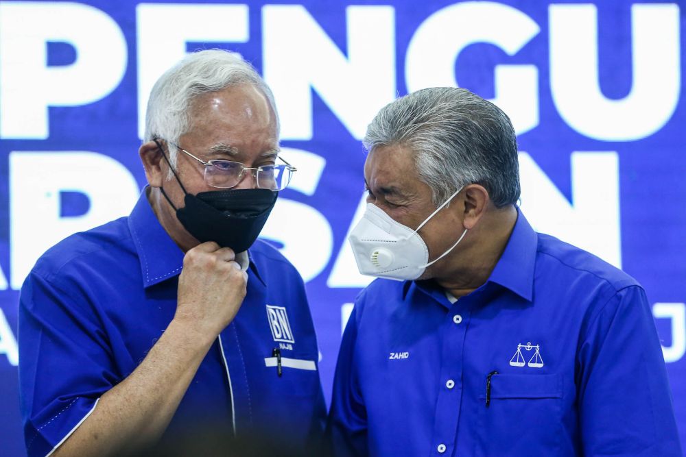 Datuk Seri Ahmad Zahid Hamidi has a chat with Datuk Seri Najib Razak at the Johor Umno Liaison Hall in Johor Baru February 24, 2022. u00e2u20acu201d Picture by Hari Anggara