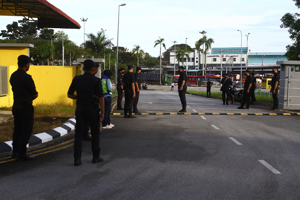 Police personnel are seen outside the nomination centre in Larkin February 26, 2022. u00e2u20acu2022 Picture by Hari Anggara