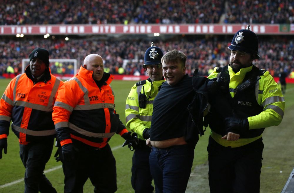 nA Leicester City fan is arrested by police after invading the pitch during the FA Cup match against Nottingham Forest at The City Ground, Nottingham February 6, 2022.u00e2u20acu2022 Reuters picn