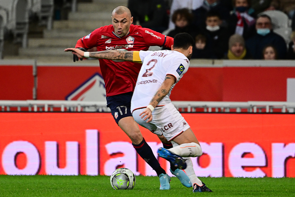 Lilleu00e2u20acu2122s forward Burak Yilmaz (left) and Metzu00e2u20acu2122 defender Dylan Bronn fight for the ball during the French L1 match at Grand Stade Pierre Mauroy stadium, in Lille, February 18, 2022. u00e2u20acu201d AFP pic 