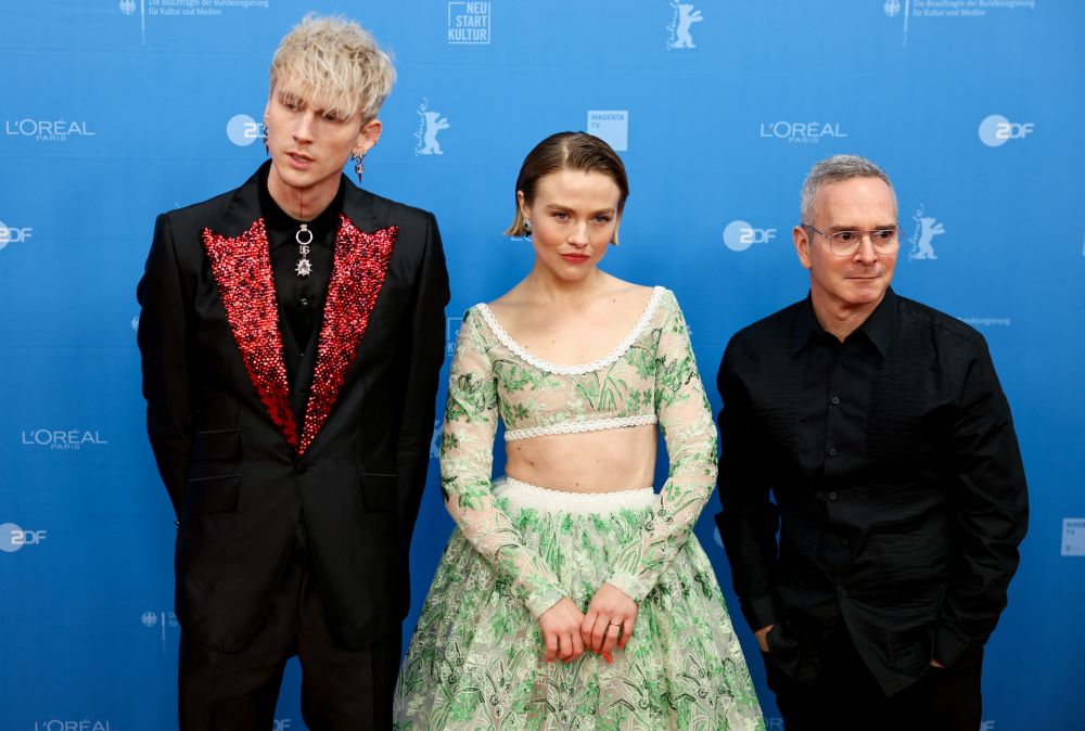 Cast members Colson Baker aka Machine Gun Kelly, Maddie Hasson and director Tim Sutton arrive at the red carpet to promote the movie 'Taurus' at the 72nd Berlinale International Film Festival in Berlin, February 13, 2022.. u00e2u20acu201d Reuters picnn