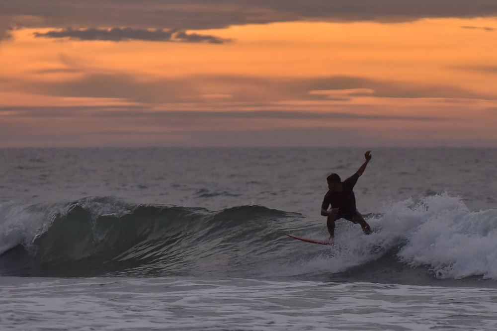 A surfer rides the waves at Karambunai beach in Sabah, February 28, 2022. u00e2u20acu201d Bernama pic 