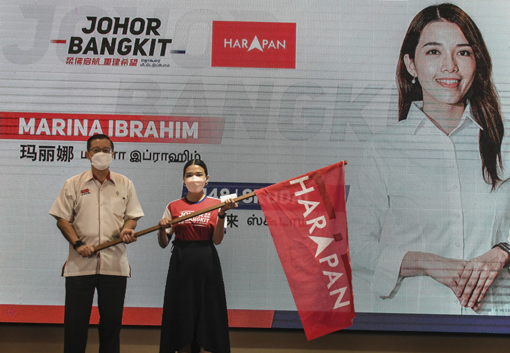 DAP secretary-general Lim Guan Eng hands the Pakatan Harapan flag to DAP candidate for Skudai state seat in the Johor state election Marina Ibrahim in Johor Baru, February 24, 2022. u00e2u20acu201d Bernama picnn