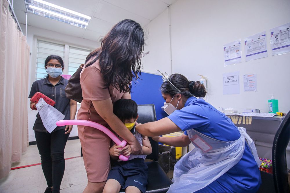 A child gets his Covid-19 jab during the National Covid-19 Immunisation Programme for Kids at the Perak Community Specialist Hospital in Ipoh February 25, 2022. u00e2u20acu201d Picture by Farhan Najib