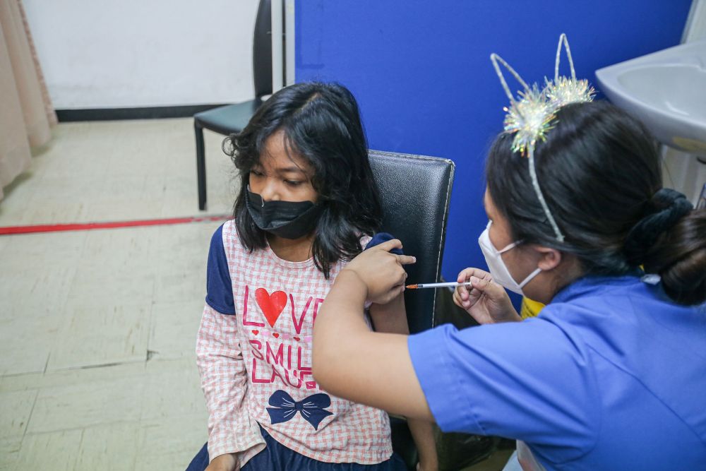 A child gets her Covid-19 jab during the National Covid-19 Immunisation Programme for Kids at the Perak Community Specialist Hospital in Ipoh February 25, 2022. u00e2u20acu201d Picture by Farhan Najib
