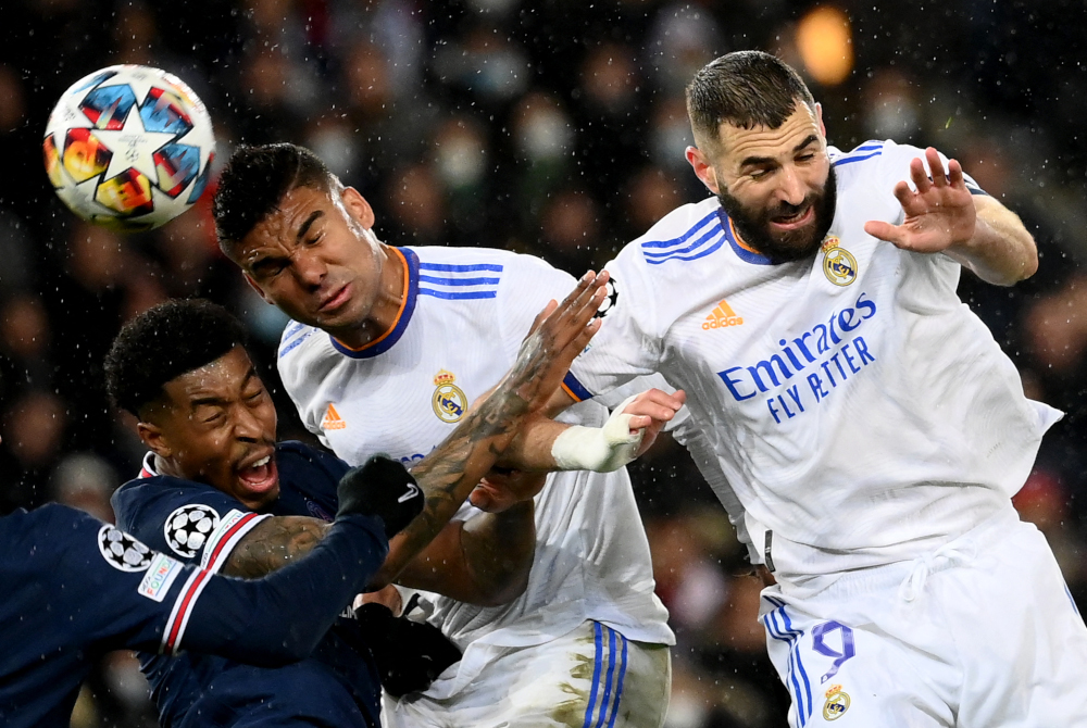 PSG defender Presnel Kimpembe (left) fights for the ball with Real Madrid midfielder Casemiro and forward Karim Benzema during the Uefa Champions League round of 16 first leg match at the Parc des Princes stadium in Paris, February 15, 2022. u00e2u20acu201d AFP pic 