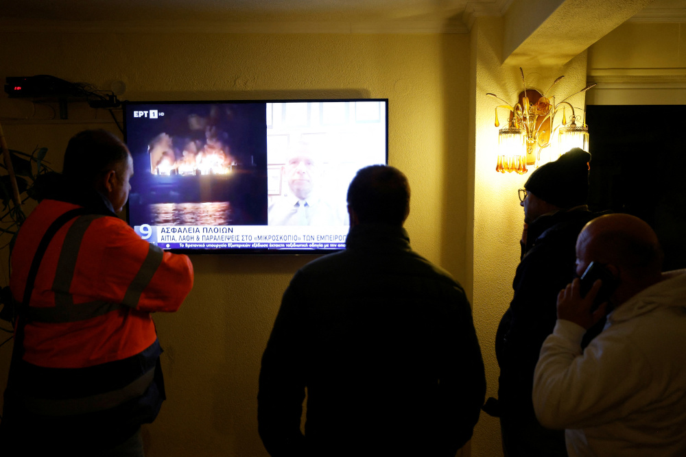 Giorgios Parlatzas from Greece and other survivors of a fire on Italian-flagged Euroferry Olympia watch the news at the Sunrise hotel in Corfu, Greece, February 18, 2022. u00e2u20acu201d Reuters pic