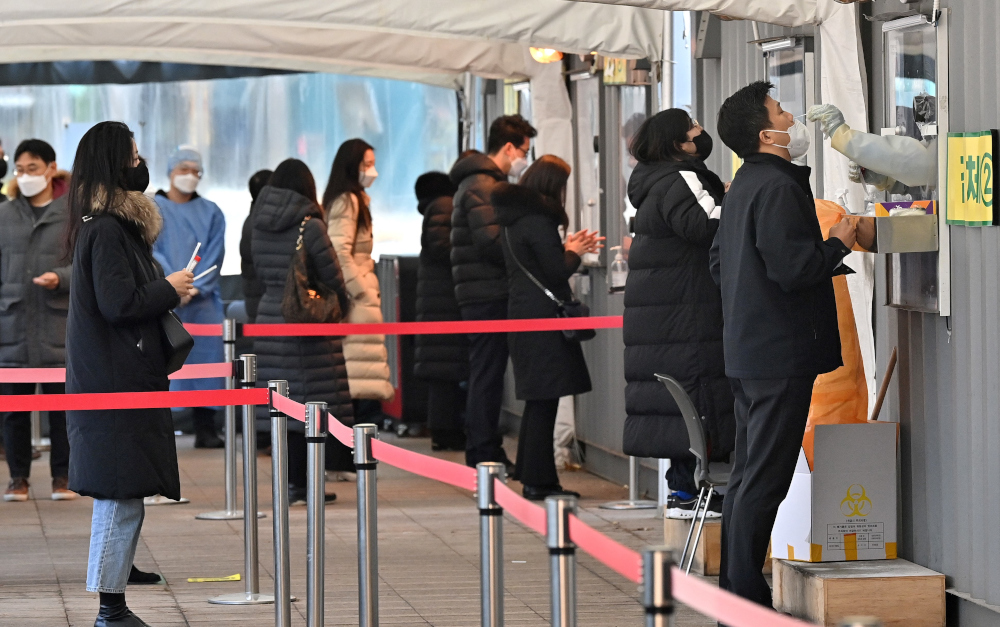 A medical staff member takes a nasal swab from a visitor as part of a test for the Covid-19 coronavirus at a virus testing centre in Seoul, January 26, 2022. u00e2u20acu201d AFP pic 