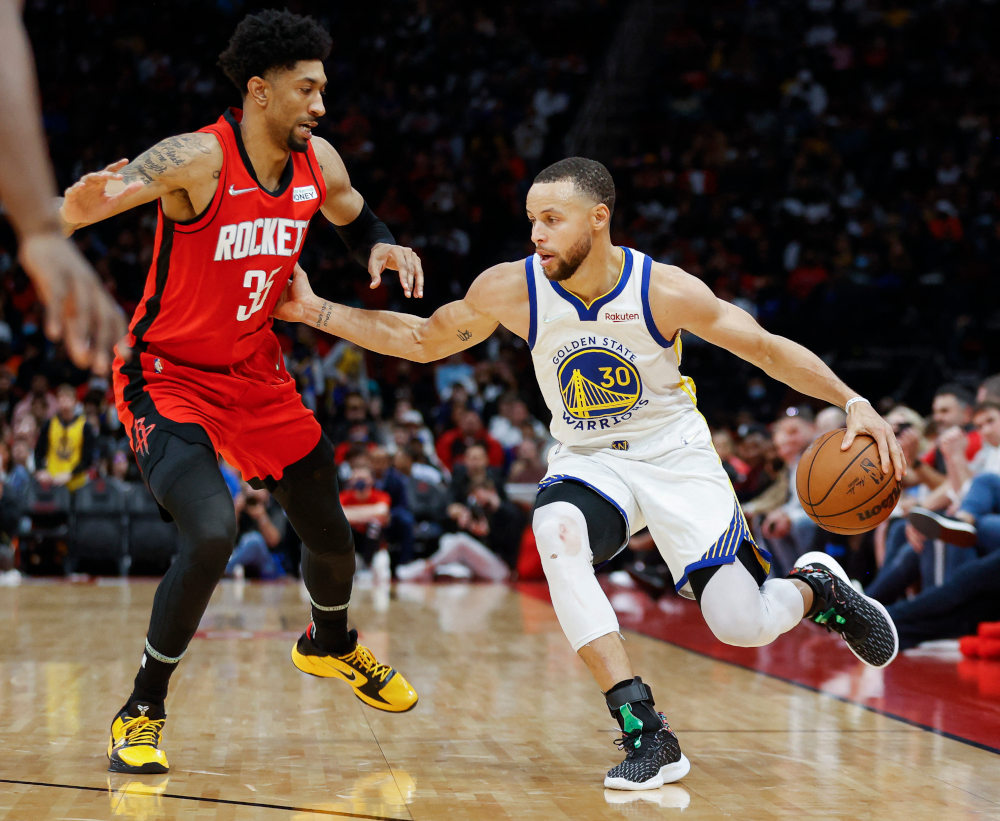Golden State Warriors guard Stephen Curry controls the ball as Houston Rockets centre Christian Wood defends during the fourth quarter at Toyota Center, Houston, Texas, January 31, 2022. u00e2u20acu201d Troy Taormina-USA Today Sports pic via Reuters 