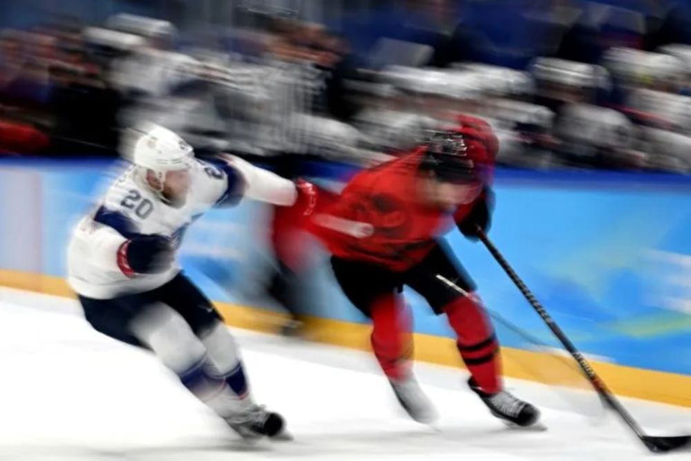 USAu00e2u20acu2122s Steven Kampfer (left) fights for the puck with Canadau00e2u20acu2122s Corban Knight at the Beijing Winter Olympics. u00e2u20acu201d AFP pic