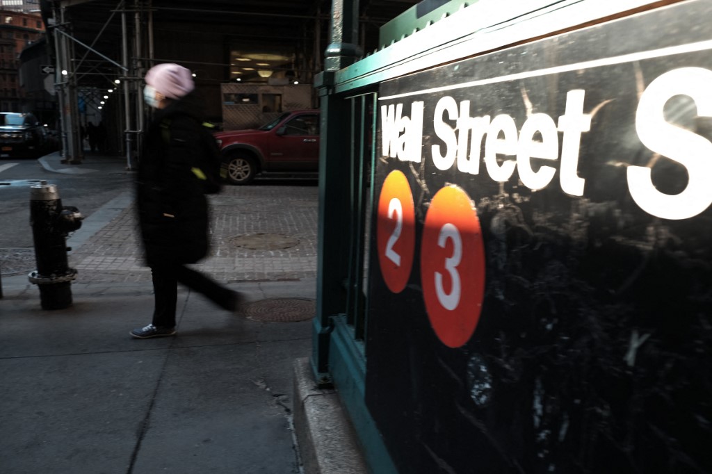 People walk along Wall Street near the New York Stock Exchange (NYSE) on February 16, 2022 in New York City. u00e2u20acu201d Getty Images via AFP