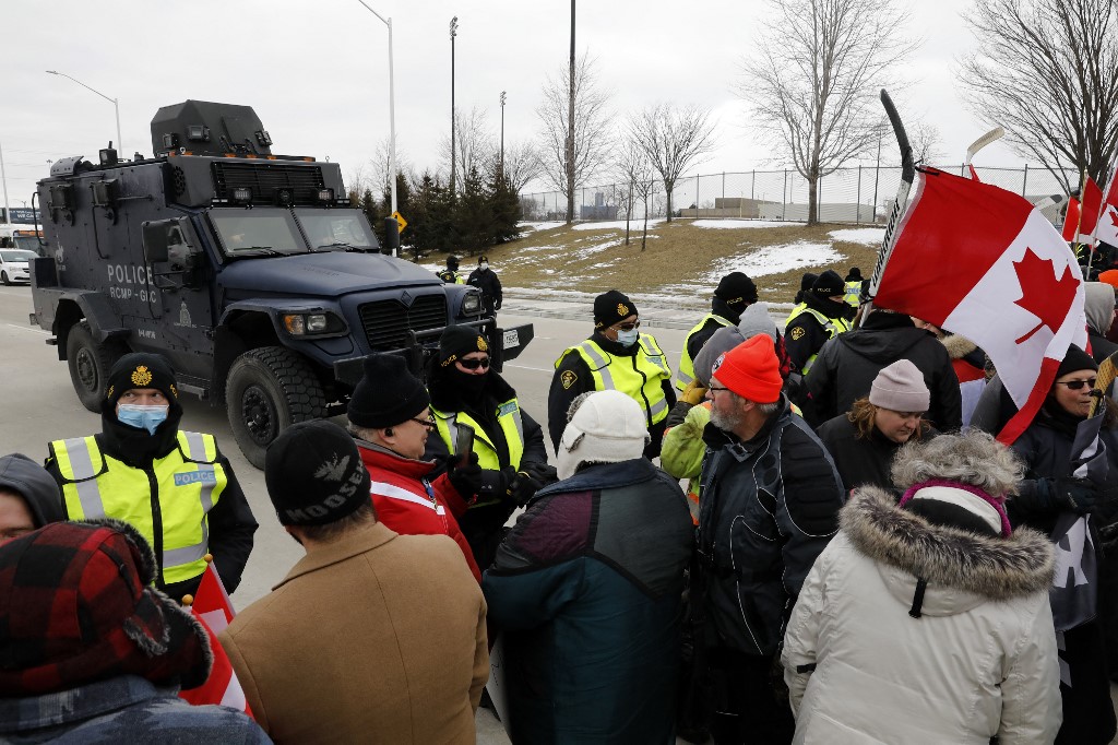 Protestors against Covid-19 vaccine mandates are stopped by police as they block the entrance to the Ambassador Bridge in Windsor, Ontario, Canada, on February 12, 2022. u00e2u20acu201d AFP pic