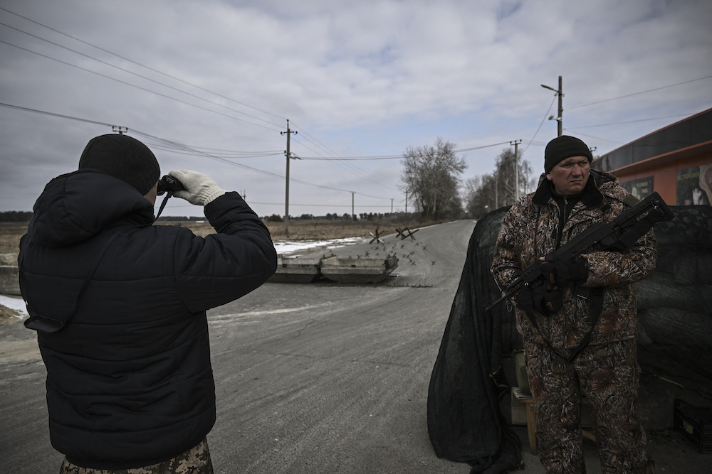 An Ukrainian serviceman looks at Russian positions through binoculars in the village of Velyka Dymerka east of Kyiv March 9, 2022. u00e2u20acu201d AFP pic