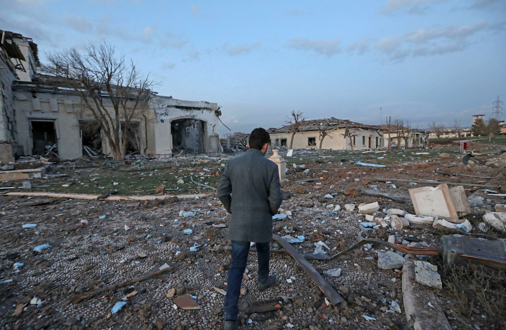 A man walks past damaged mansions following an overnight attack in Arbil, the capital of the northern Iraqi Kurdish autonomous region, on March 13, 2022. u00e2u20acu201d AFP pic