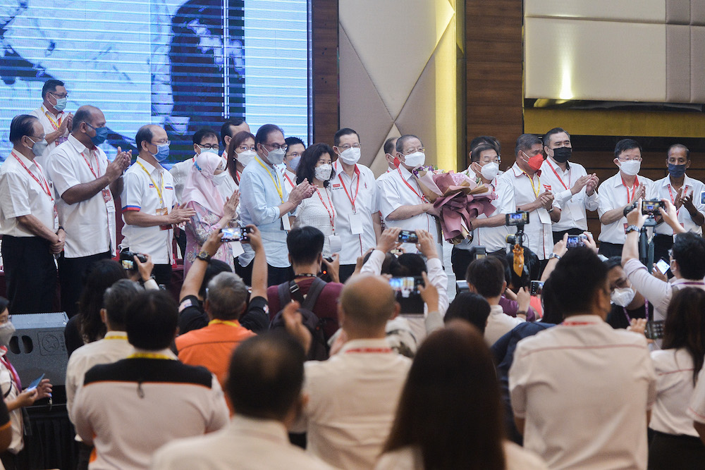 Attendees at DAP’s 17th annual congress give a standing ovation to party advisor Lim Kit Siang who announced his retirement from politics, March 20, 2022. — Picture by Miera Zulyana
