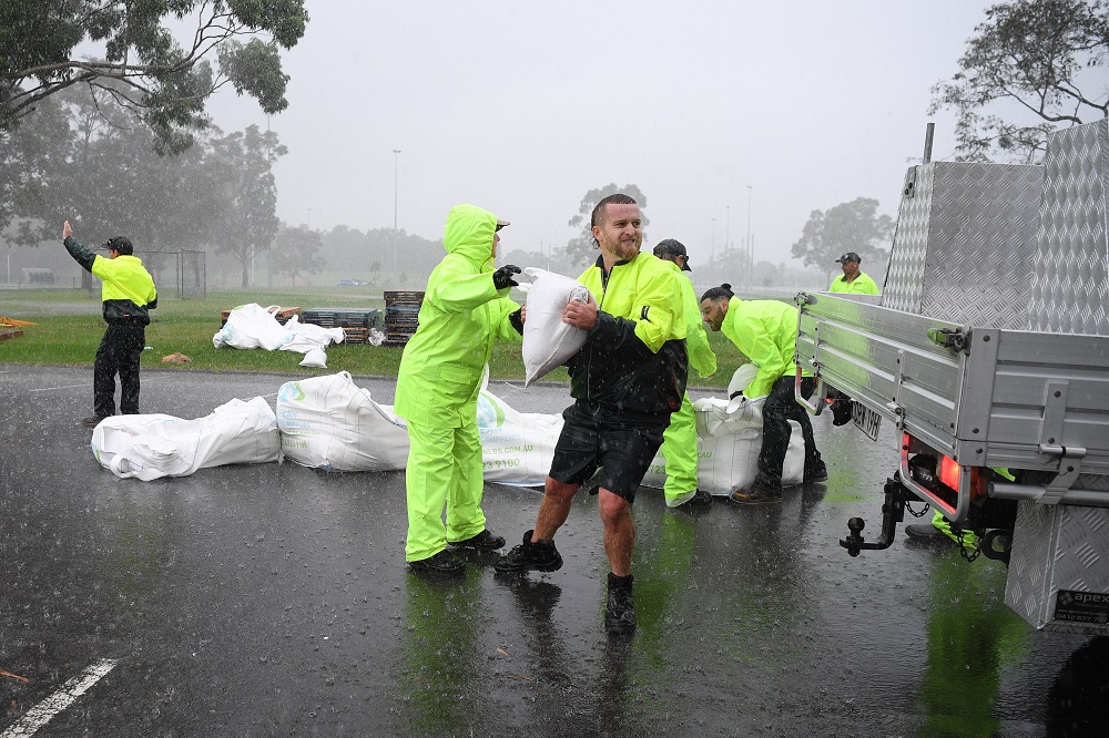 Penrith City Council workers load sand bags into residents cars at Jamison Park in Sydney March 2, 2022. u00e2u20acu201d AAP Image/Dean Lewins via AFP