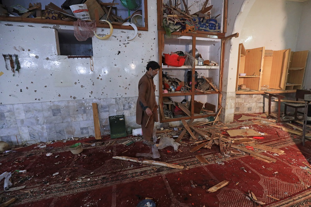 A man walks amid the damages at the prayer hall after a bomb blast inside a mosque during Friday prayers in Peshawar, Pakistan March 4, 2022. u00e2u20acu201d Reuters pic