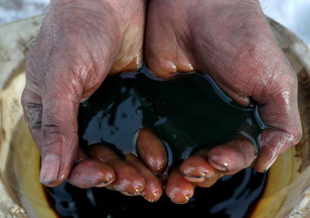 An employee holds a sample of crude oil at the Yarakta oilfield, owned by Irkutsk Oil Co, in the Irkutsk region, Russia on March 11, 2019. u00e2u20acu201d Reuters pic