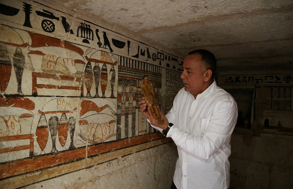 Secretary-General of the Supreme Council of Antiquities, Mostafa Waziri, displays a small statue at a recently discovered tomb at the Saqqara area, in Giza March 19, 2022. u00e2u20acu201d Reuters pic