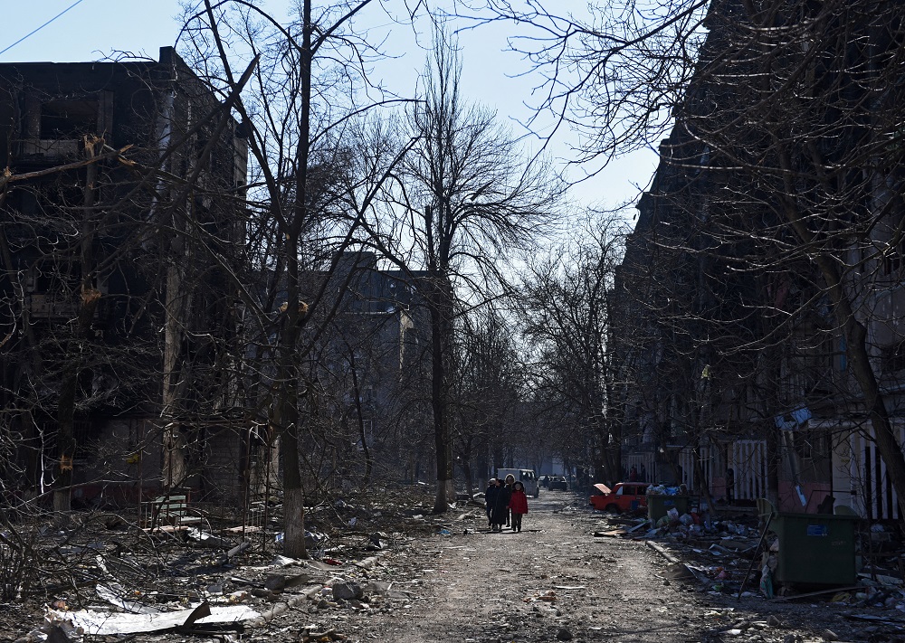 Local residents walk near residential buildings which were damaged during Ukraine-Russia conflict in the besieged southern port city of Mariupol, Ukraine March 18, 2022. u00e2u20acu201d Reuters pic