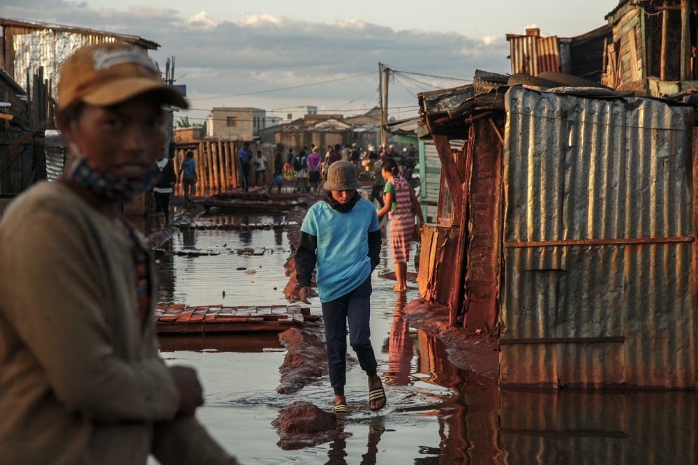 Residents walk in a flooded area of the 67-hectare Ankasina neighbourhood in Antananarivo. u00e2u20acu201d AFP pic