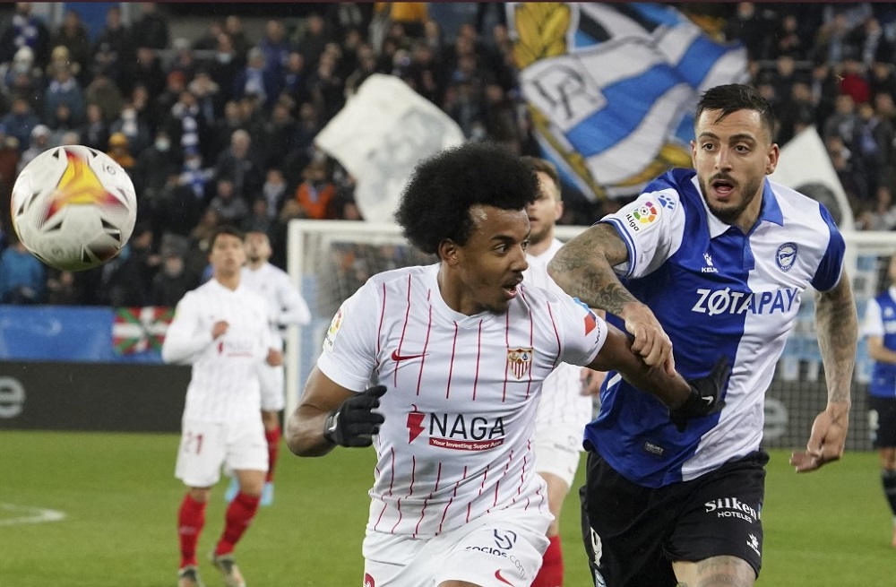 Sevilla's French defender Jules Kounde (left) fights for the ball with Alaves' Spanish forward Joselu during the Spanish league football match between Deportivo Alaves and Sevilla FC at the Mendizorroza stadium in Vitoria March 4, 2022. u00e2u20acu201d AFP pic