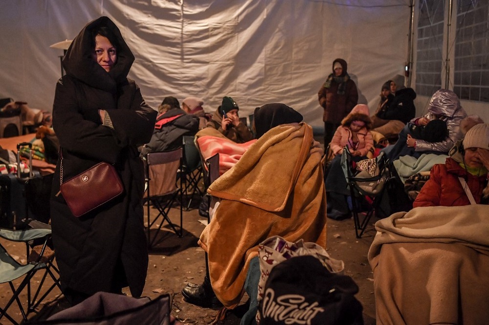 Refugees from Ukraine rest in a tent after crossing the Ukrainian border with Poland, at the Medyka border crossing, southeastern Poland March 11, 2022. u00e2u20acu201d AFP pic
