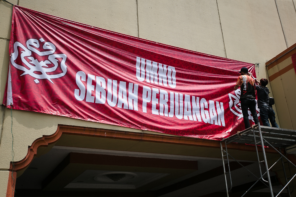 Workers installing banners and flags ahead for Umno General Assembly at PWTC, Kuala Lumpur March 15, 2022. u00e2u20acu201d Picture by Devan Manuel 