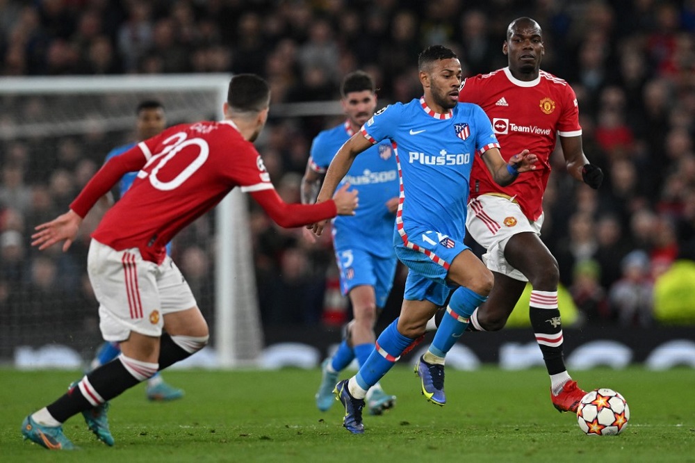 Atletico Madridu00e2u20acu2122s Brazilian defender Renan Lodi (second right) runs with the ball during the Uefa Champions League round of 16 second leg football match against Manchester United at Old Trafford stadium in Manchester March 15, 2022. u00e2u20acu201d AFP pic