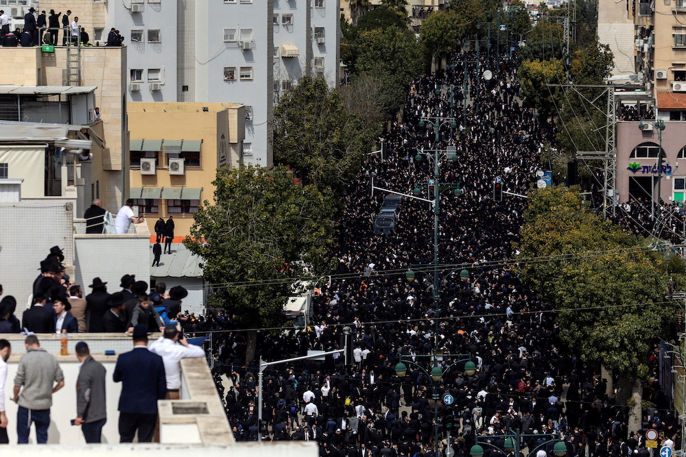 Ultra-Orthodox Jewish men gather ahead of the funeral ceremony of prominent rabbi Chaim Kanievsky who died at 94, close to a cemetery in Bnei Brak, near Tel Aviv, Israel March 20, 2022. u00e2u20acu201d Reuters picn                n