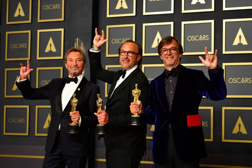 Producers Philippe Rousselet (left), Fabrice Gianfermi (right) and Patrick Wachsberger (centre) pose with the award for Best Picture for u00e2u20acu02dcCODAu00e2u20acu2122 during the 94th Oscars at the Dolby Theatre in Hollywood March 27, 2022. u00e2u20acu201d AFP pic