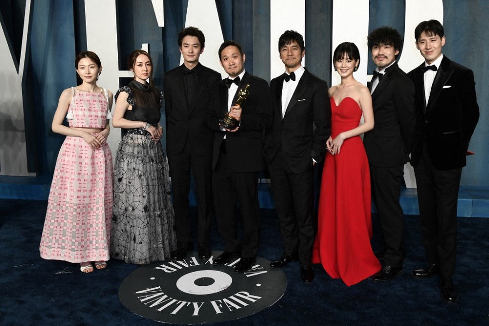 Japanese director Ryusuke Hamaguchi (centre) poses with the award for Best International Feature Film for u00e2u20acu02dcDrive My Caru00e2u20acu2122, alongside the cast, in Beverly Hills, California March 27, 2022. u00e2u20acu201d AFP pic