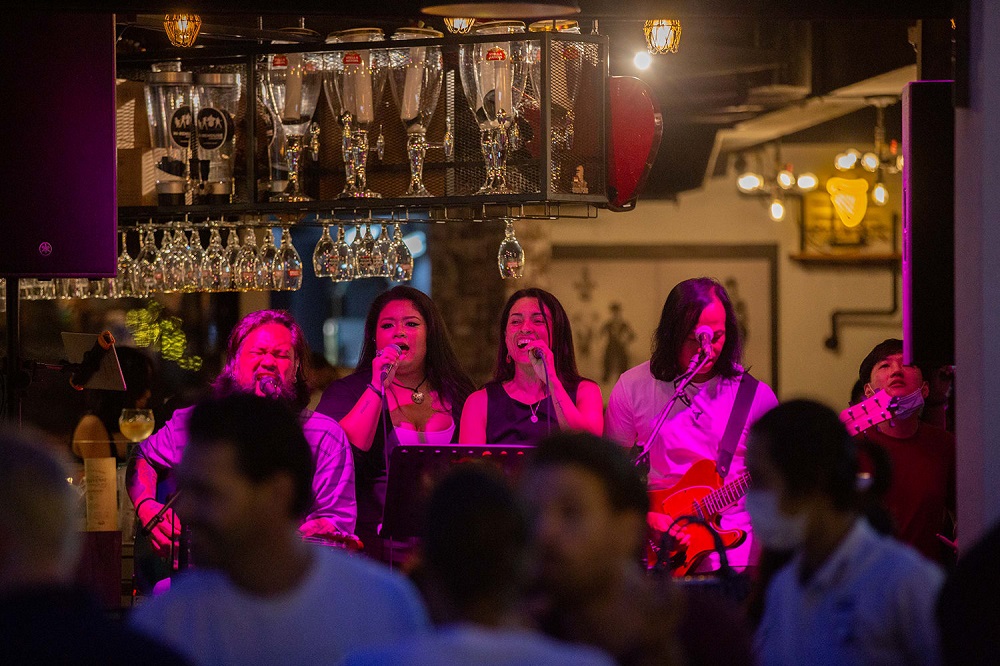 Musicians performing live at a bar in Clarke Quay March 29, 2022. — TODAY pic