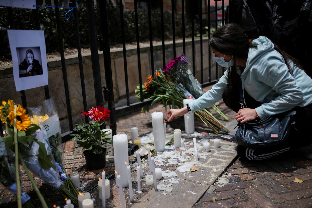A woman lights candles outside the Casa Medina hotel where Taylor Hawkins, the band's drummer, died before appearing at the Estereo Picnic festival in Bogota, Colombia March 26, 2022. u00e2u20acu201d Reuters pic