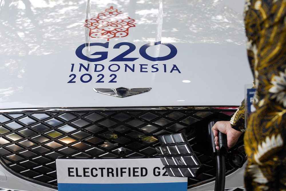 An official charges an electric car after the launch of the first public electric vehicle charging station for electric vehicles transporting world leaders during the G20 conference in October, in the town of Nusa Dua on Bali March 25, 2022. u00e2u20acu201d AFP pic