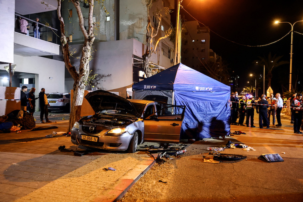 The wreckage of gunmens' car is seen following an attack in which people were killed on a main street in Hadera, Israel March 27, 2022. u00e2u20acu201d Reuters pic