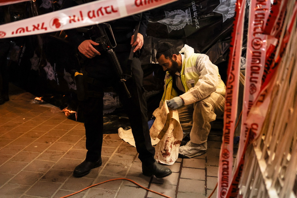 An Israeli police forensic expert works at the scene of a fatal shooting attack on a street in Bnei Brak, Israel March 29, 2022. u00e2u20acu201d Reuters pic