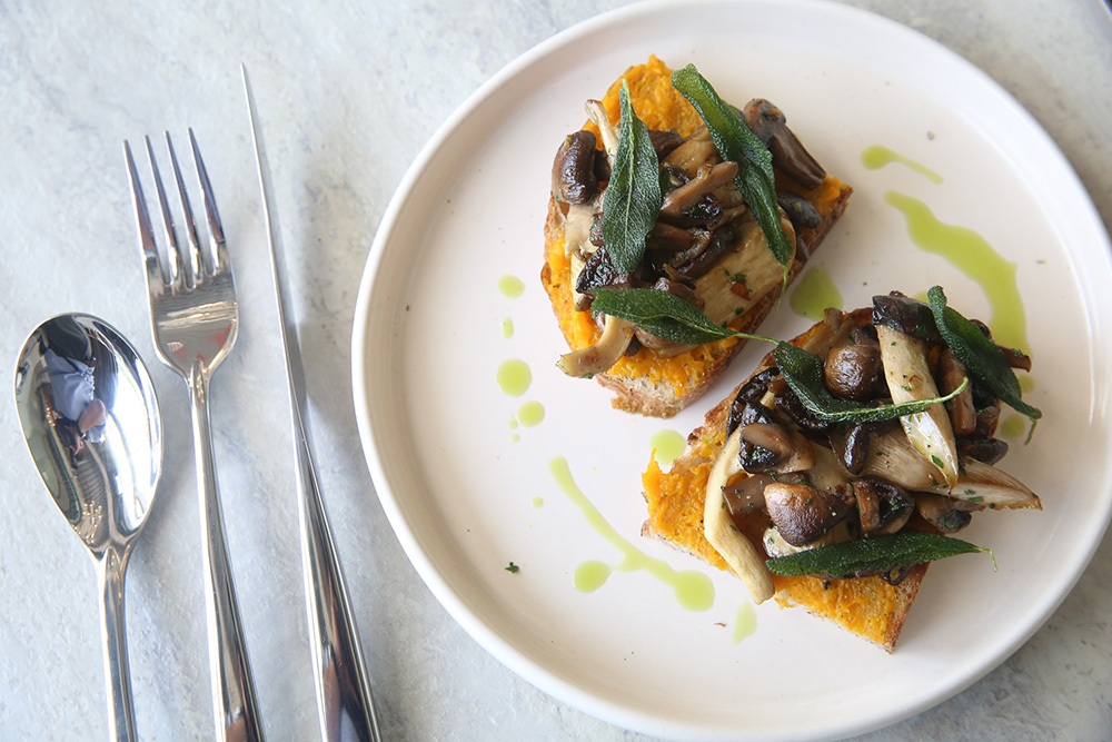 Nibble on this bruschetta with pumpkin puree topped with roasted mushrooms and sage leaves from Mabel by Cookhouse.