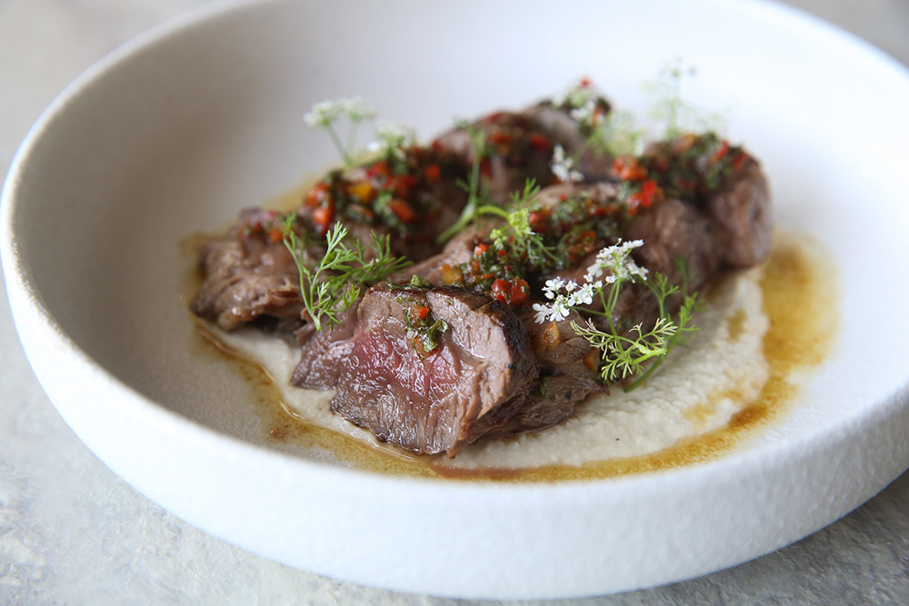 Enjoy Mabel by Cookhouse's fork tender beef eye fillet with a touch of cashew cream, chimichurri and 'gula Melaka' soy sauce burnt butter.