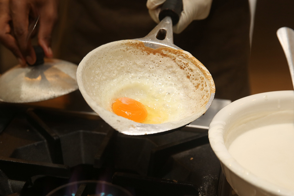 Who can resist a freshly made 'appam' made by Aliyaa with a fried egg.