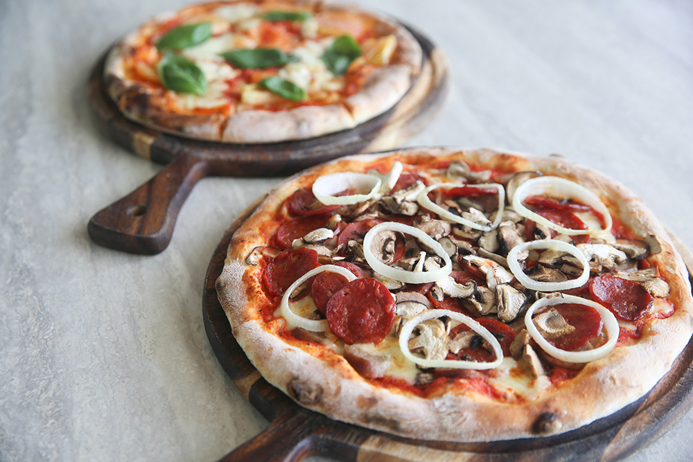 Expect wood fire hand tossed pizzas like the Basic B and Garlic Girl from Pie Guys.
