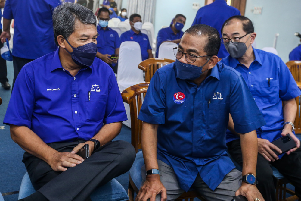 Johor state election director Datuk Seri Mohamad Hasan with Umno vice president Datuk Seri Khaled Nordin (right) at the Johor State Umno Liaison Hall in Johor Baru, March 1, 2022. u00e2u20acu2022Picture by Hari Anggara
