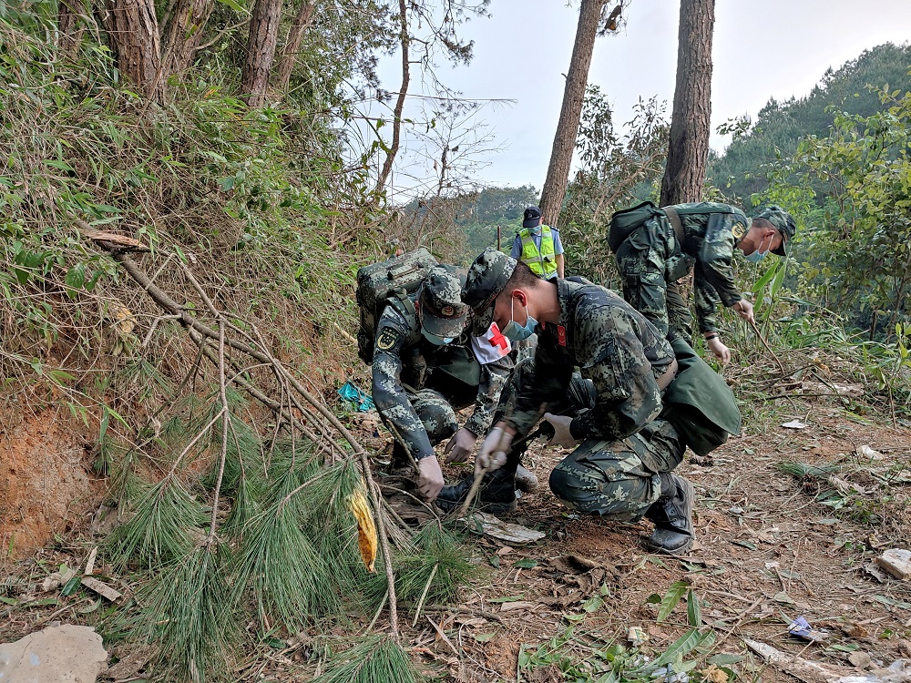 Paramilitary police officers work at the site where a China Eastern Airlines Boeing 737-800 plane flying from Kunming to Guangzhou crashed, in Wuzhou, Guangxi Zhuang Autonomous Region, China March 21, 2022. u00e2u20acu2022 China Daily via Reuters