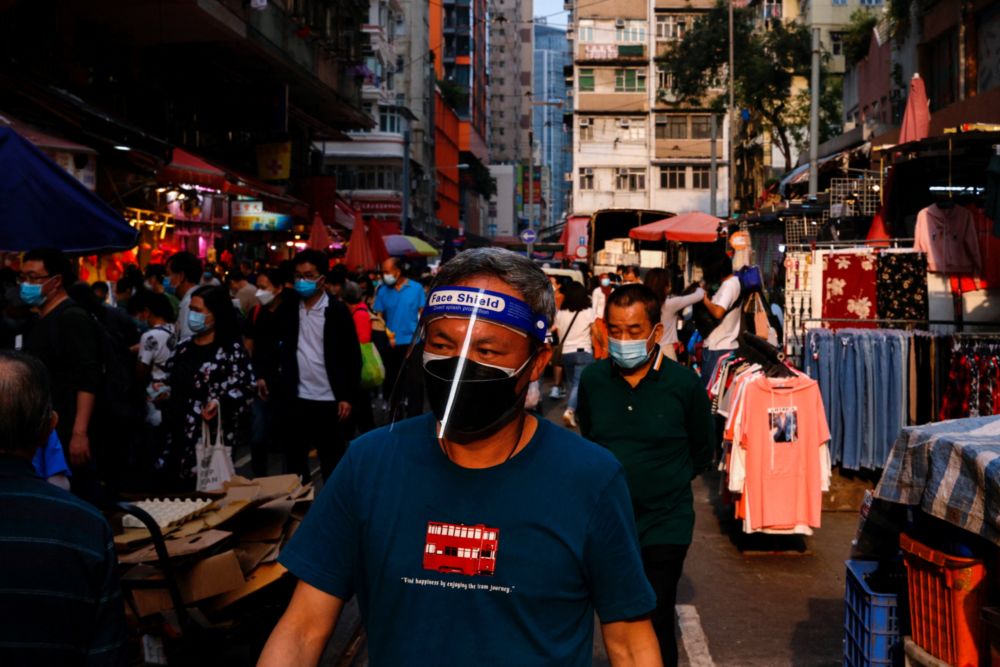 A man wearing face mask and shield shops at wet market during the coronavirus disease (Covid-19) pandemic in Hong Kong, China, March 16, 2022. u00e2u20acu201d Reuters pic