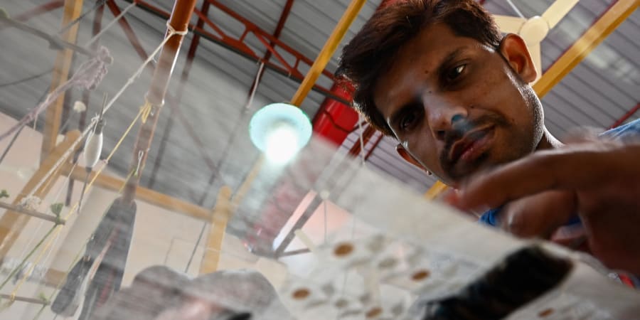 A weaver uses a handloom to make traditional muslin garments at the Dhakai Muslin Project facility in Narayanganj. u00e2u20acu2022 ETX Studio pic