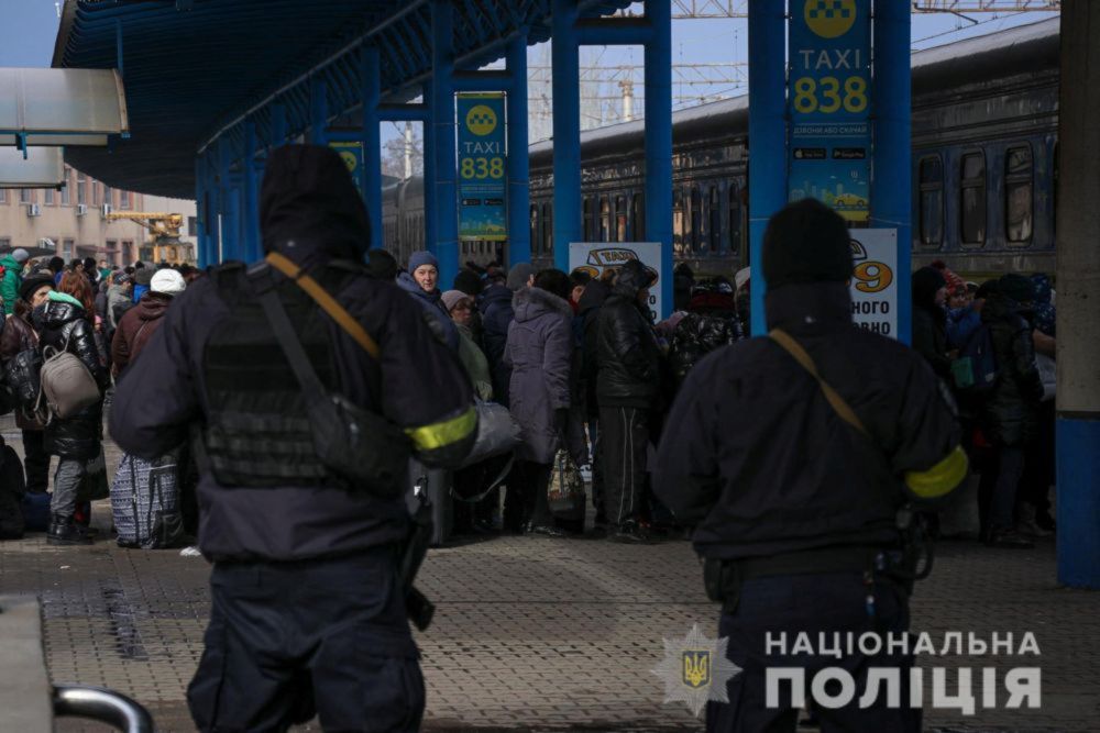 People fleeing from Mariupol amid Russia's invasion of Ukraine stand at a railway station in Zaporizhzhia, Ukraine, on March 16, 2022. u00e2u20acu201d Press service of the National Police of Ukraine/Handout via Reuters