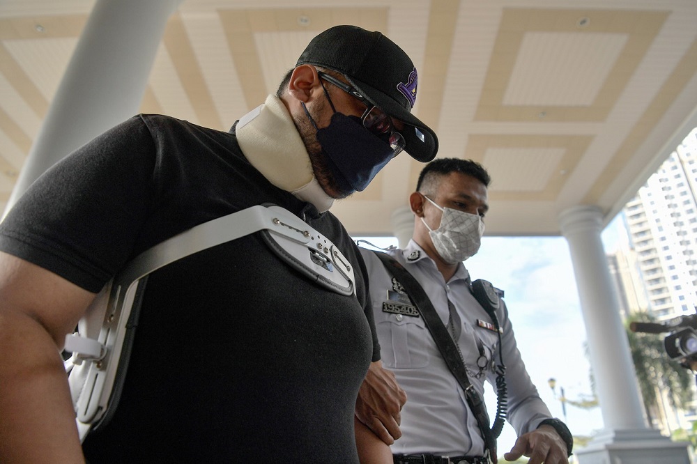 Aliff Asyraf Abu (left) arrives at the Magistrateu00e2u20acu2122s Court in Kuala Lumpur March 16, 2022. u00e2u20acu201d Bernama pic