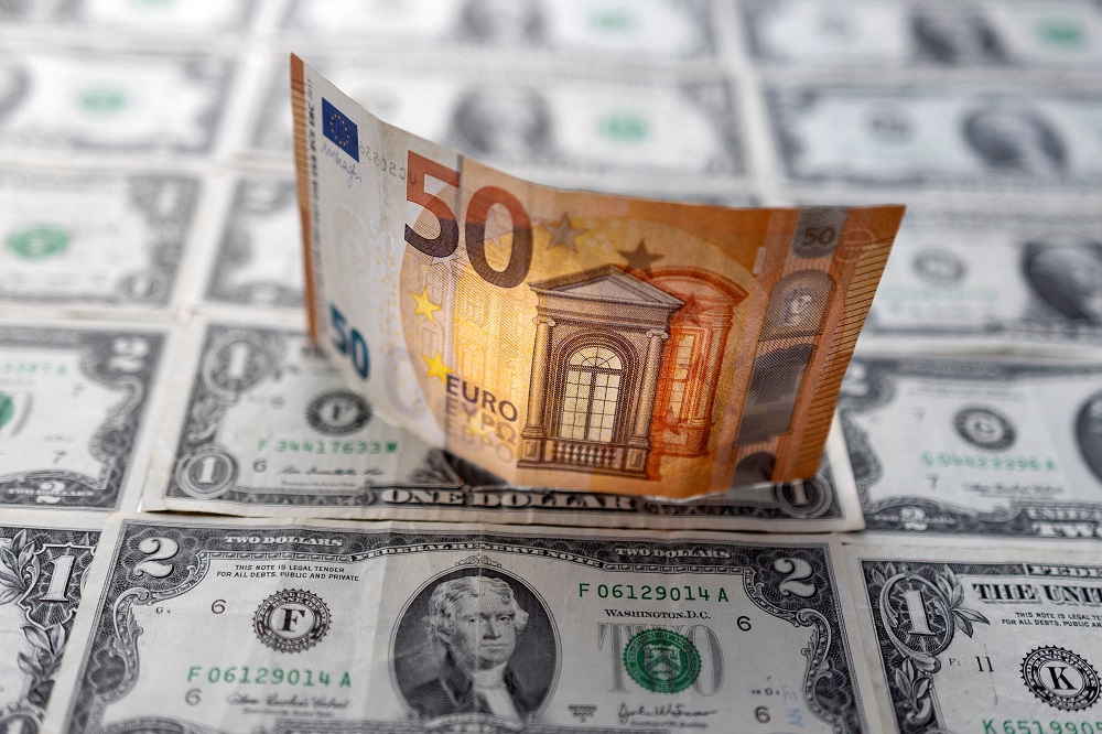 A Euro banknote is displayed on US dollar banknotes in this illustration taken on February 14, 2022. u00e2u20acu2022 Reuters pic