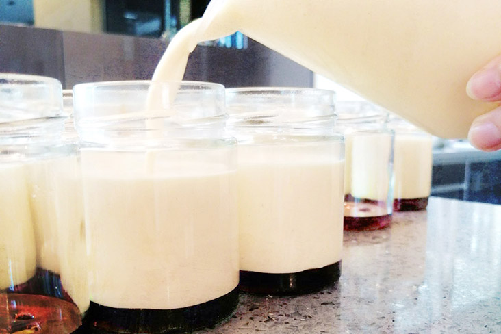 Topping each jar with the custard, infused with real vanilla seeds.