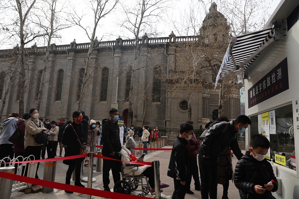 People line up at a mobile nucleic acid testing site in Beijing, China March 16, 2022. u00e2u20acu2022 Reuters pic